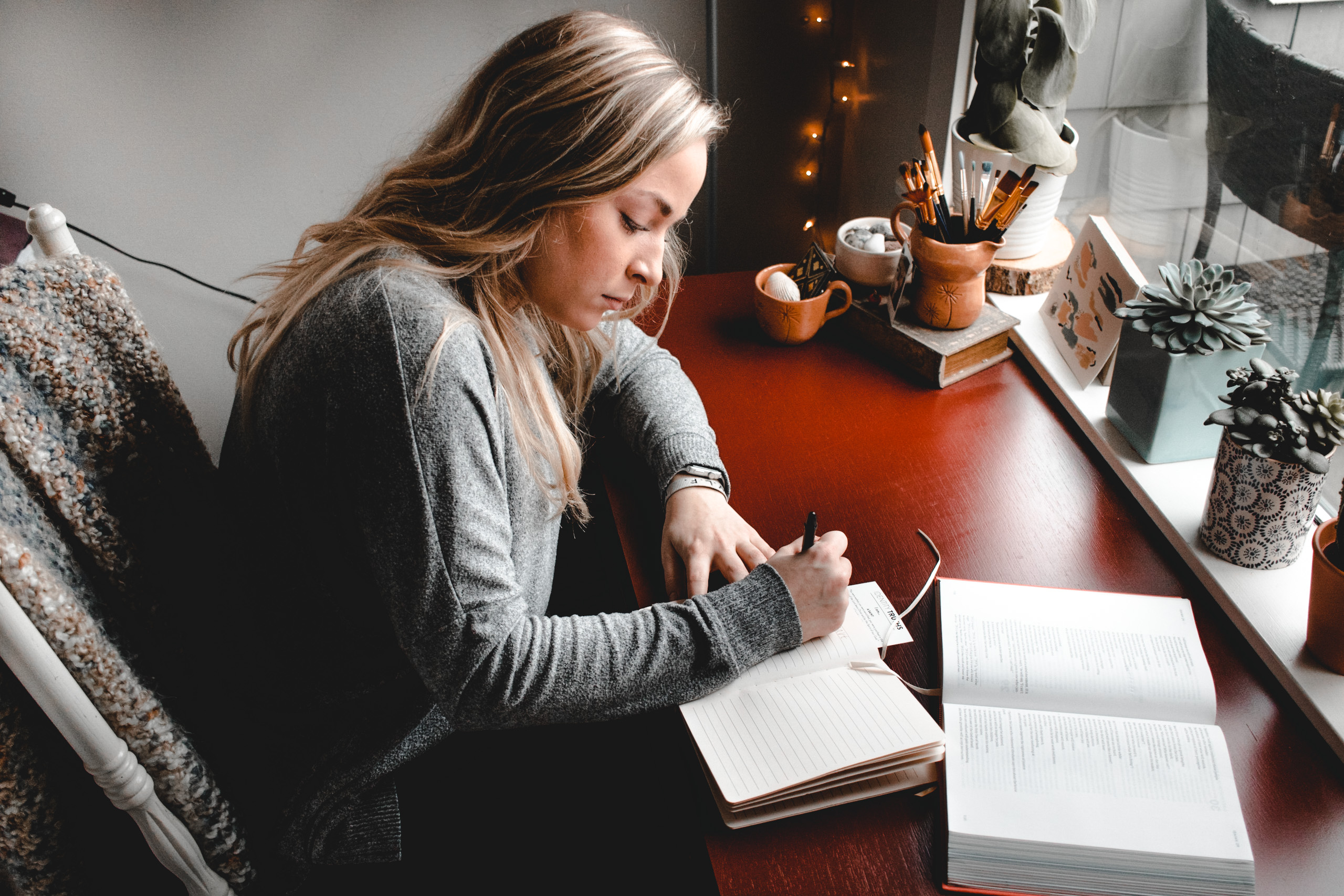 A woman reads her Bible and takes notes.