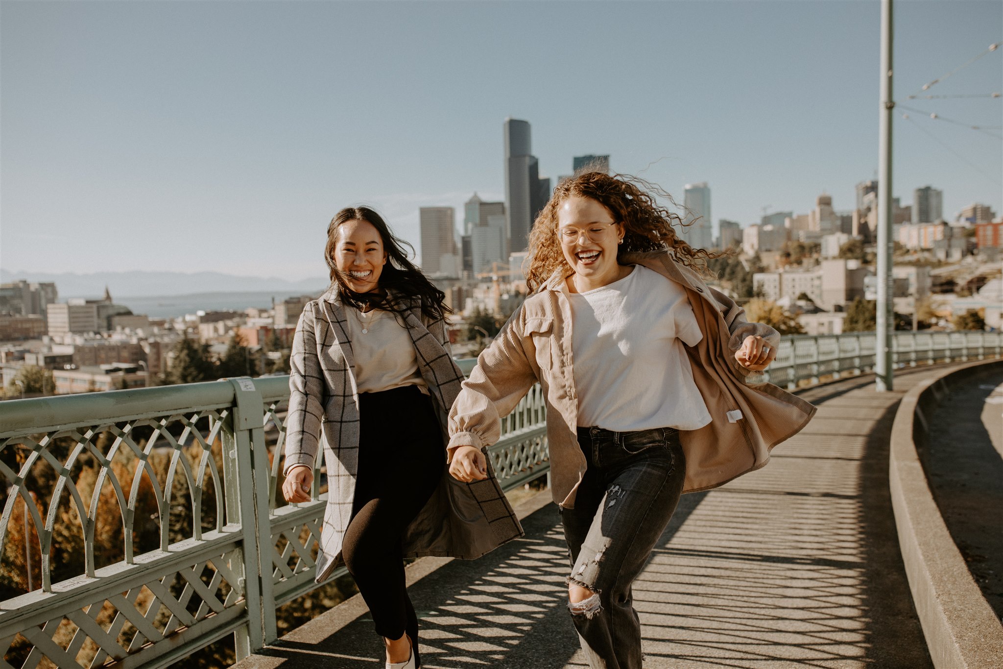 Two women run on a bridge in Downtown Seattle.