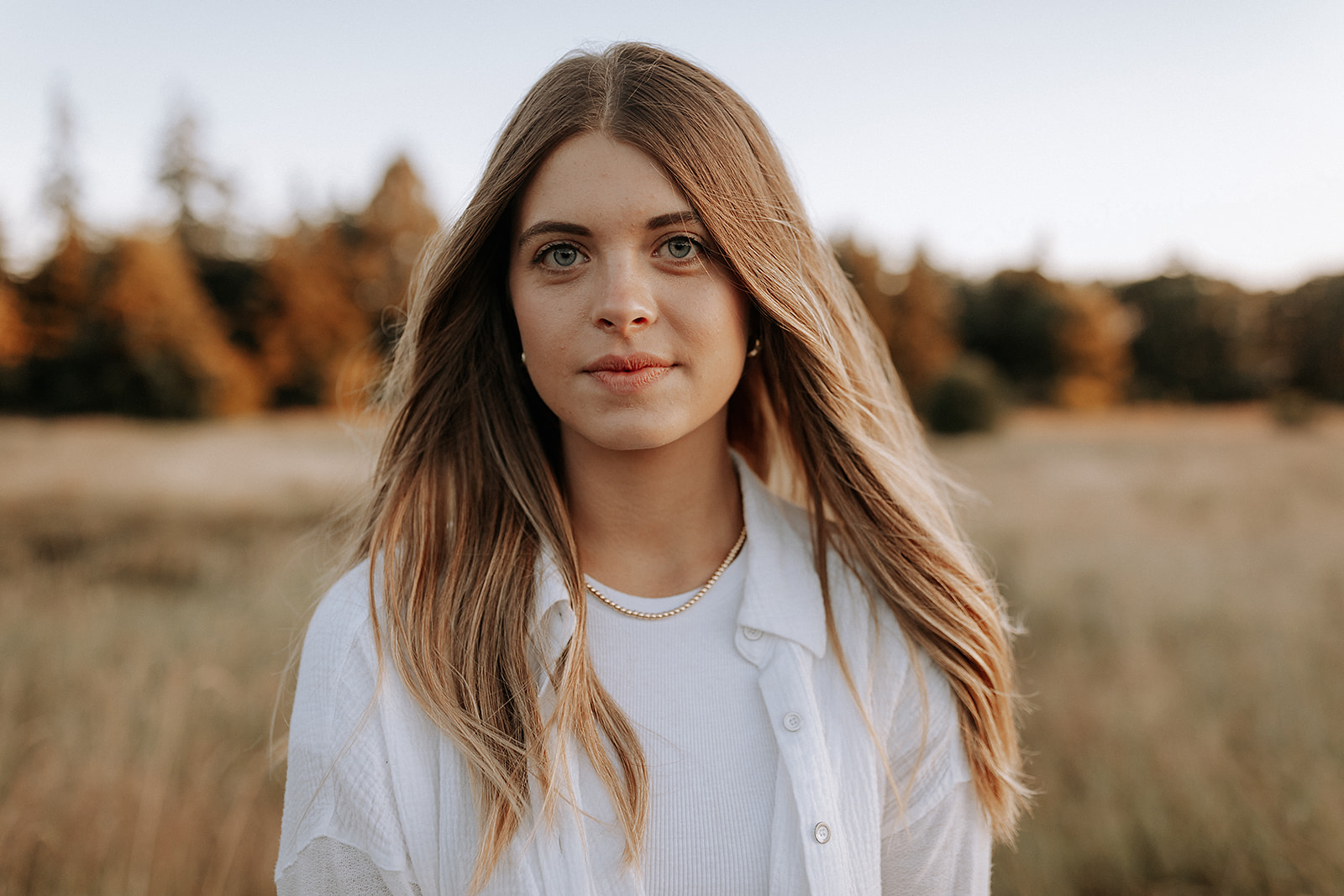 A young woman looks directly into the camera.