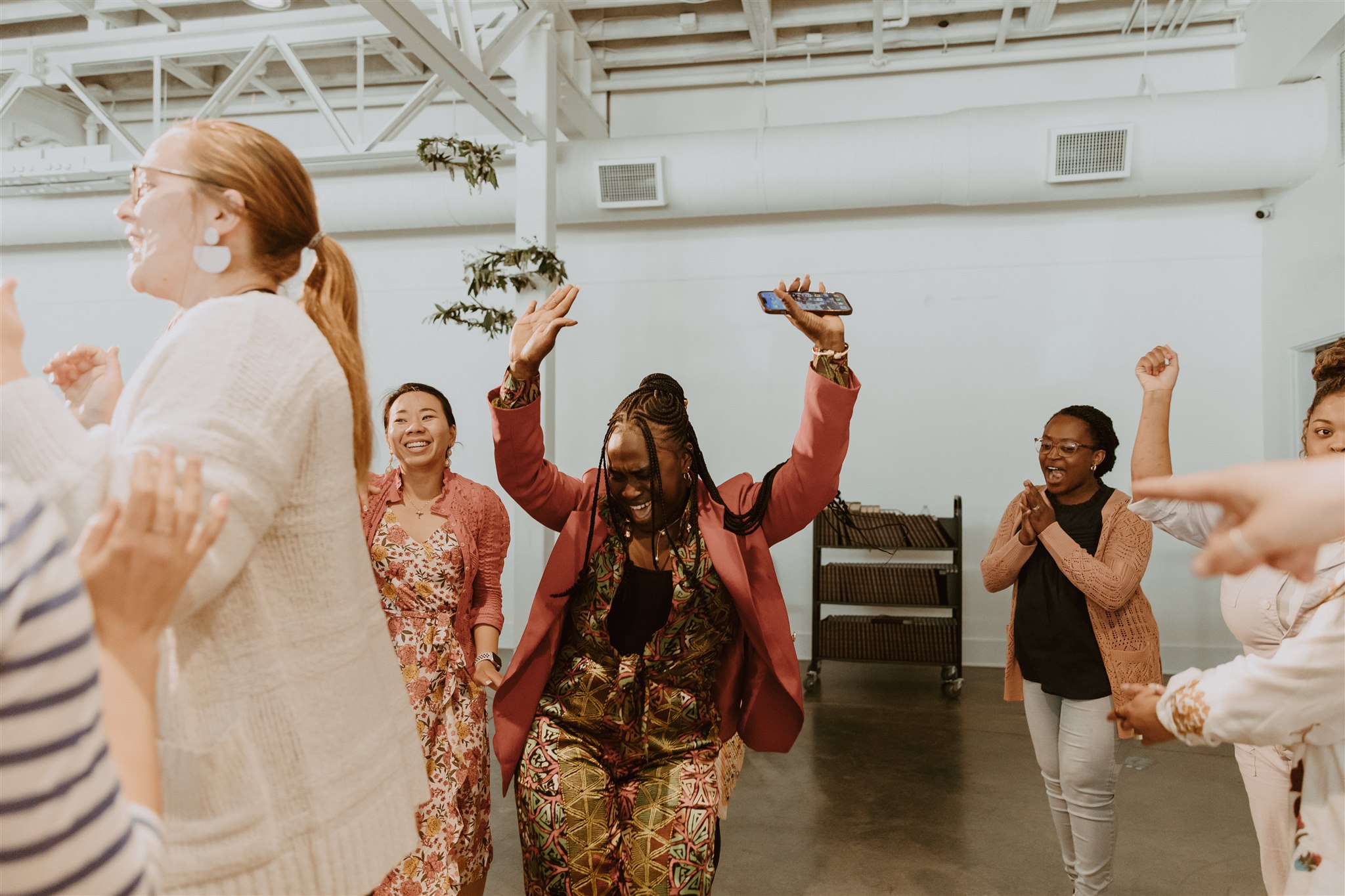 Women dance together at a Live Salted Conference in Seattle, WA.